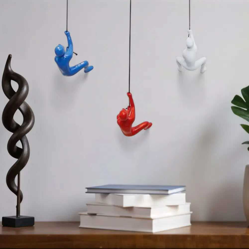 Set of Three Blue Red And White Resin Climbing Man Hanging Dimensional Sculpture HomeRoots