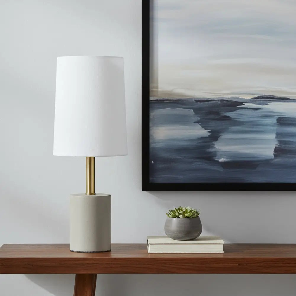 18" Gray And Antiqued Brass Concrete And Metal Table Lamp With White Drum Shade HomeRoots